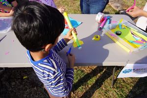 Boy building a colorful rocket at the craft table