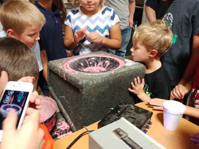 Kids watching oobleck dance on a speaker