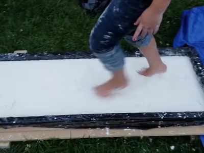 Child running barefoot across the oobleck trough