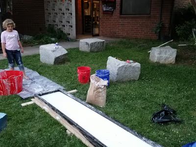 The oobleck trough setup with mixing buckets on the grass