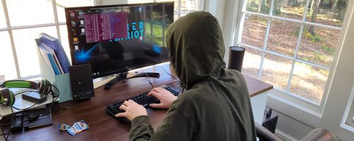 Student working through a cybersecurity challenge on a laptop