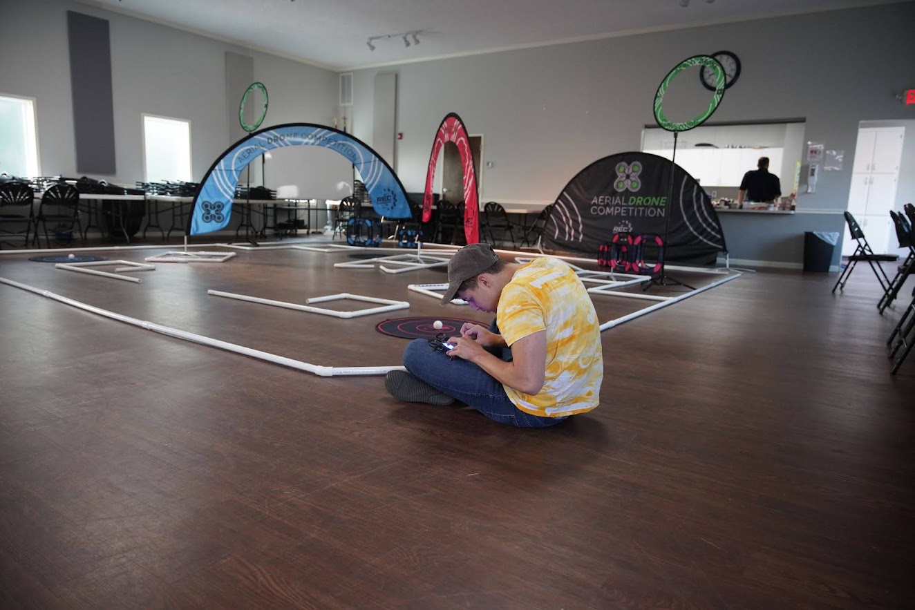 Pilot controlling drone at Aerial Drone Competition course