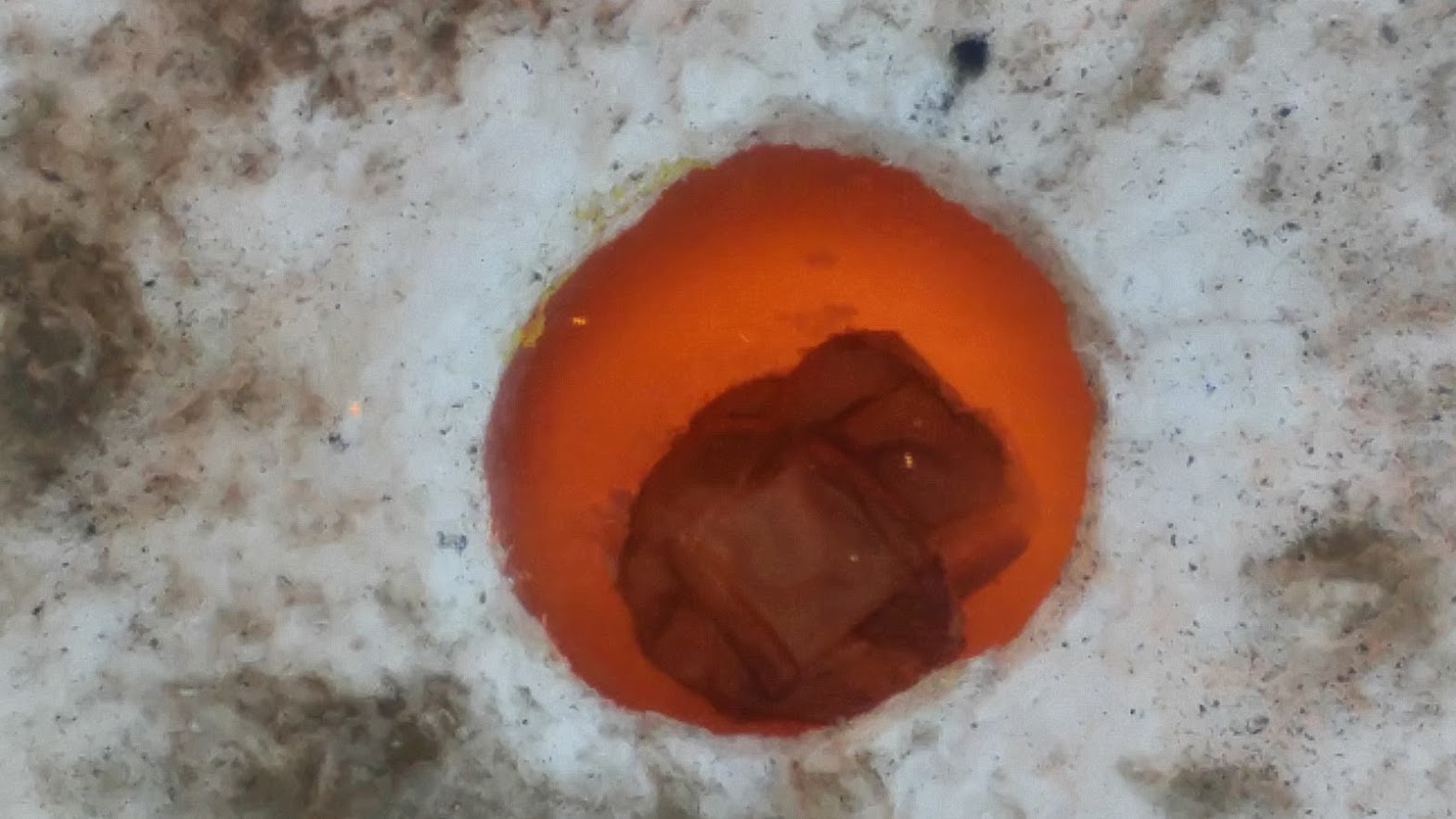 Close-up of molten aluminum glowing in furnace