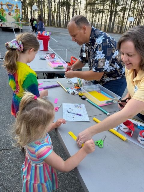 Young children building rockets with instructor