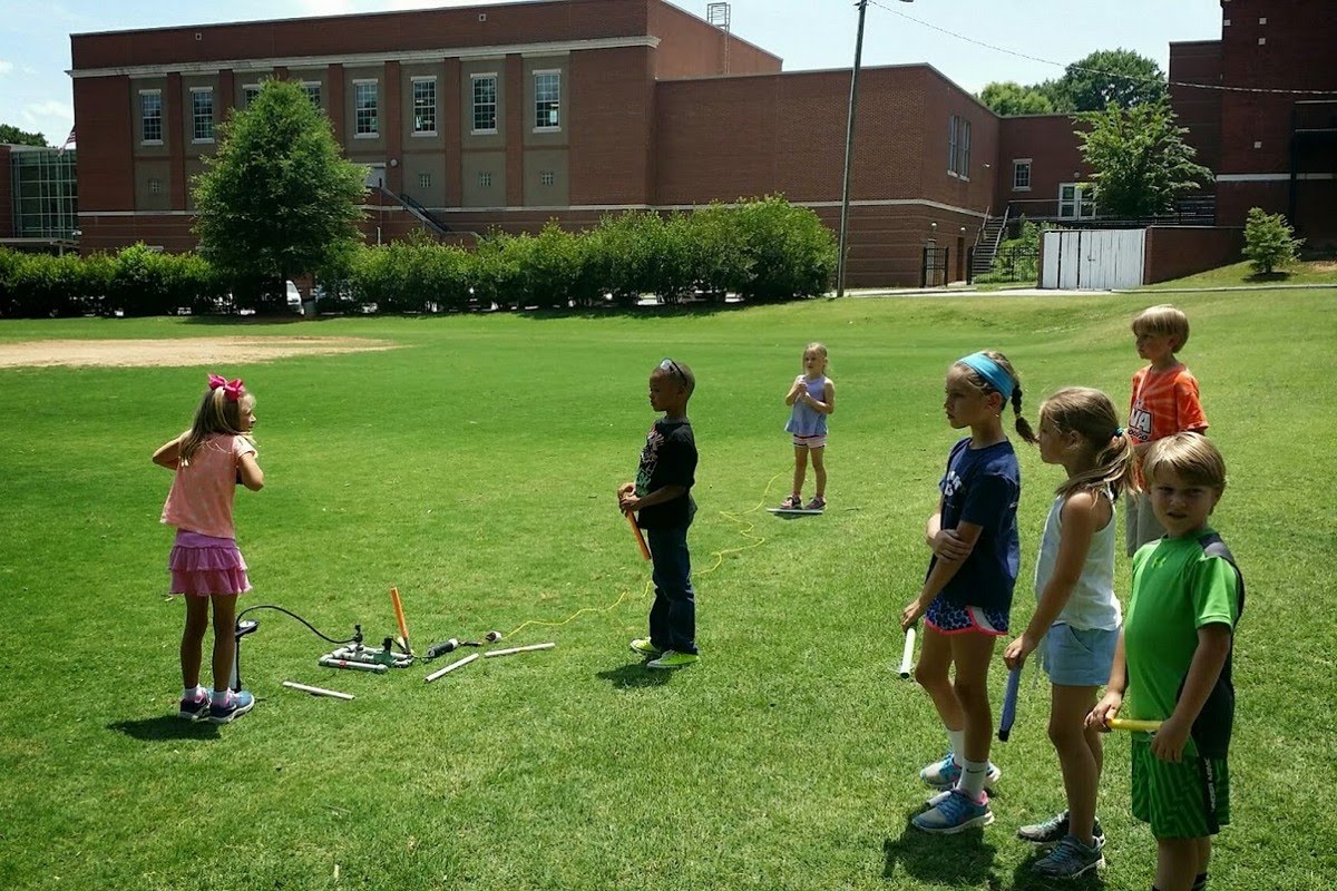 Children lined up with their rockets ready to launch