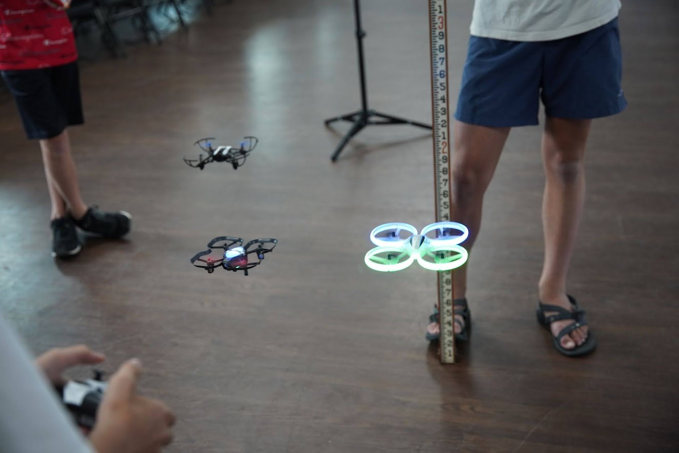 Three drones hovering during indoor flight practice