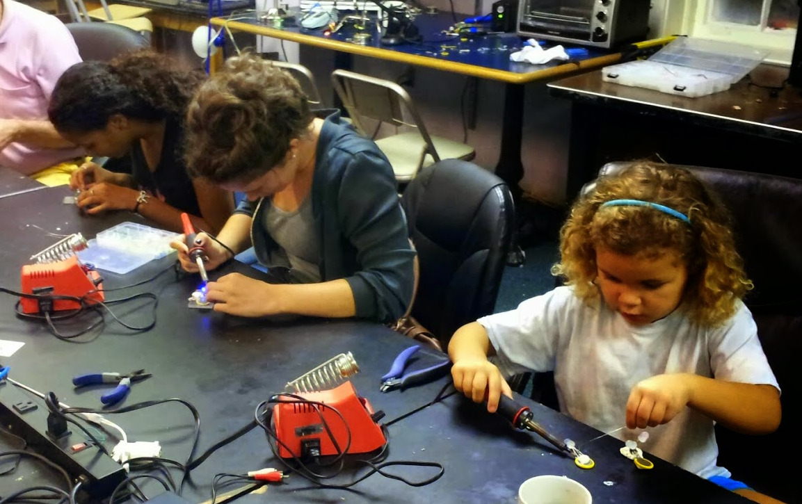 Student focused on soldering a circuit